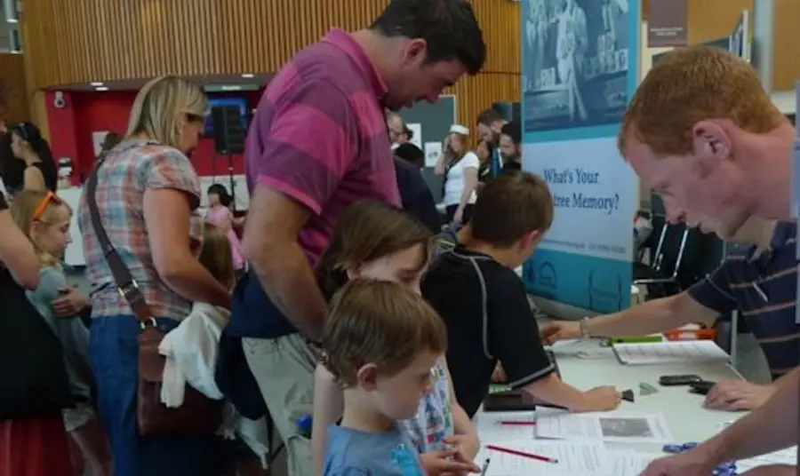 People visiting a Rowntree Society pop-up exhibition