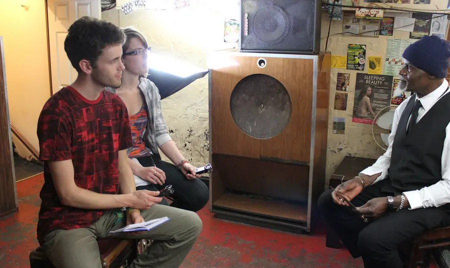 Young people interviewing for the radio station