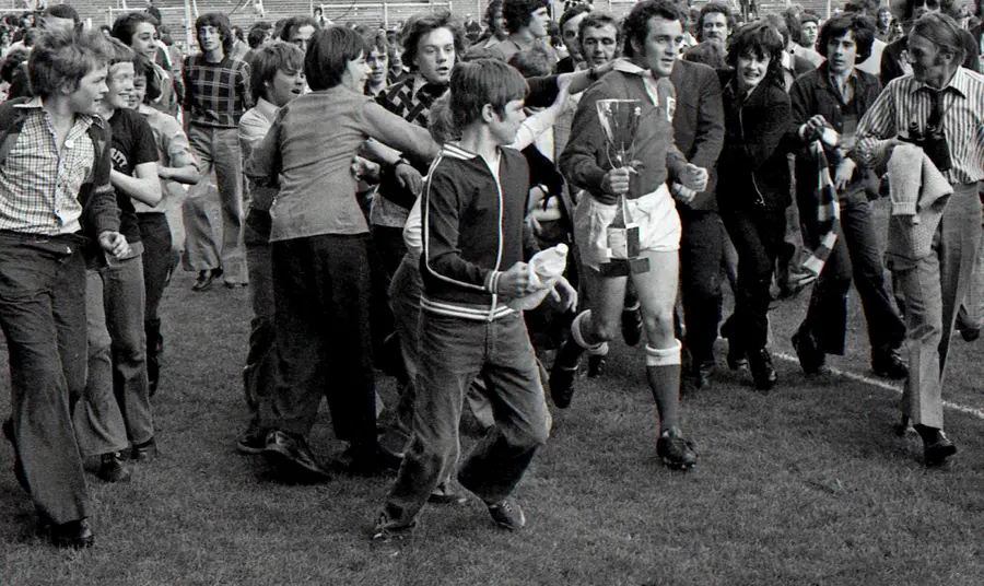 Scarlets captain Phil Bennett surrounded by fans after the club were crowned Welsh 'cup kings' in 1975
