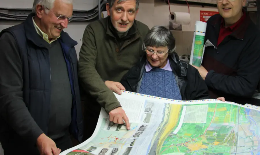 Volunteers from the Hadleigh and Thundersley Community Archive Group examine a walking map