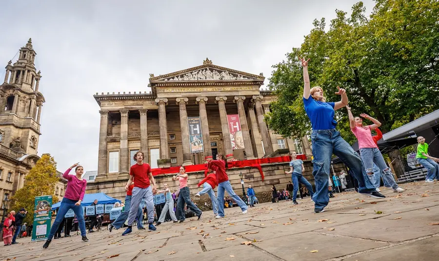 Dancers perform in front of The Harris to celebrate the museum's re-opening.