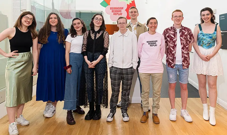 a group of young adults stand in a line