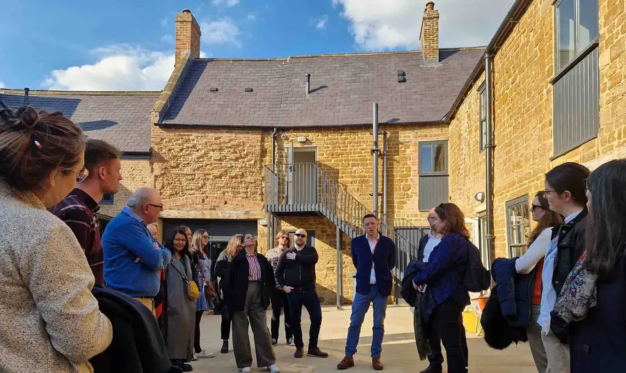 Visitors stand in the courtyard of the Old Black Lion.