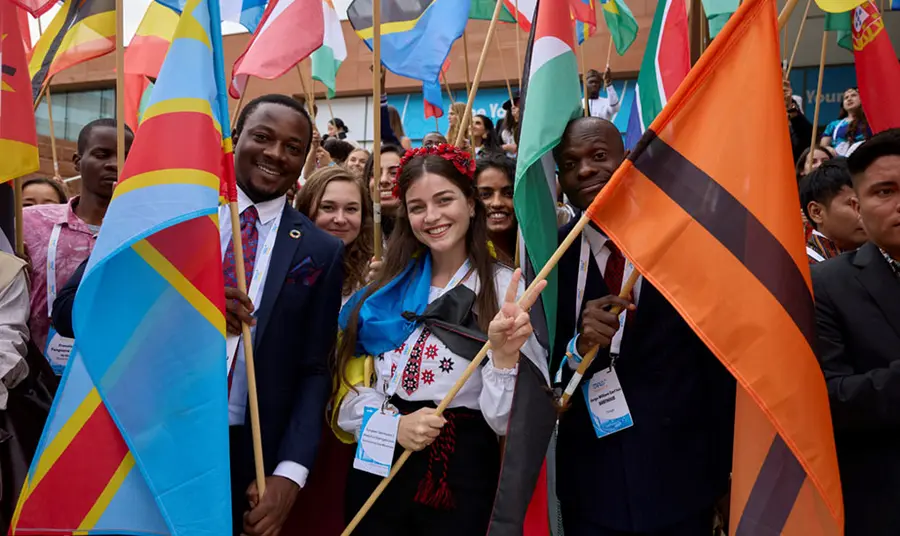 A close up of a group of people holding flags