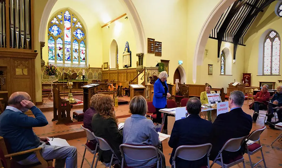 a group of people having a meeting inside a church