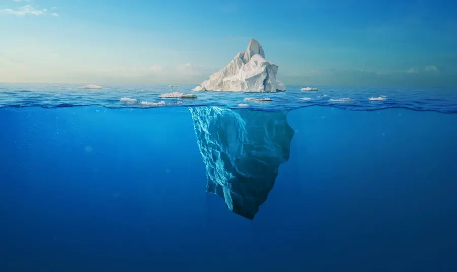An iceberg, seen above and below the waterline