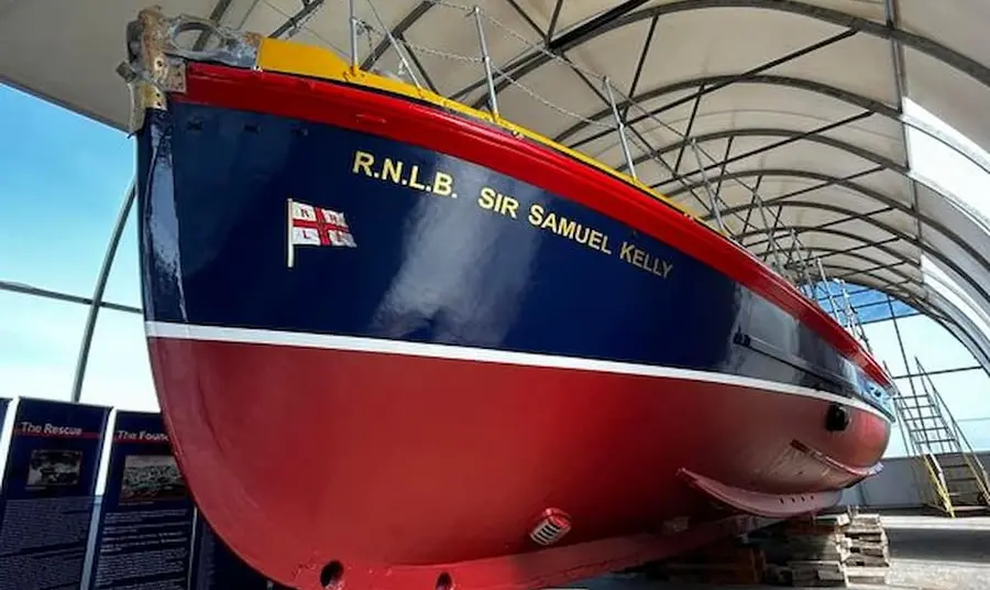 The Sir Samuel Kelly Lifeboat is on display on land.