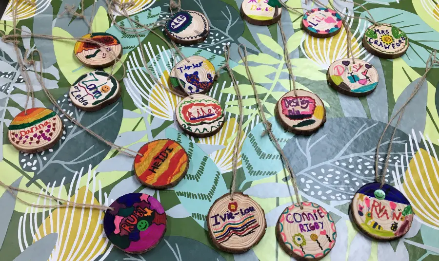 Colourful wooden badges created by schoolchildren during the project