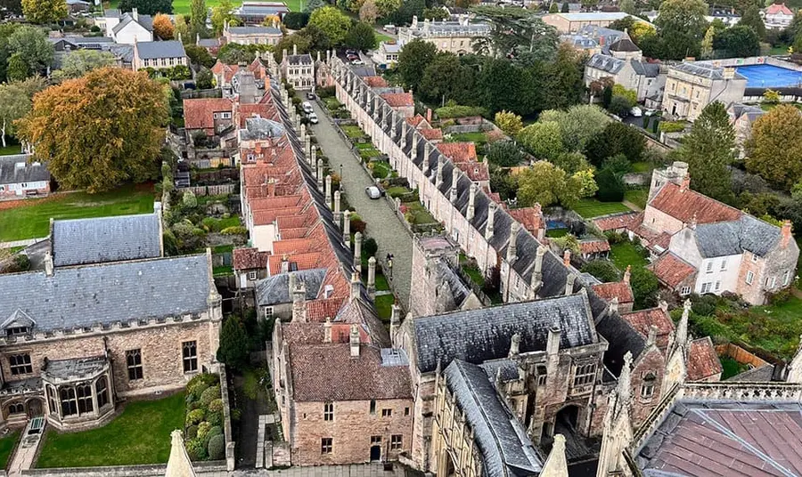 An aerial photo of a row of terraced medieval houses in a small town