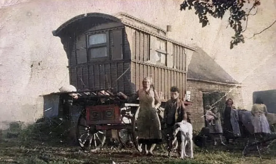A 1940s photograph of a family standing in front of a wagon