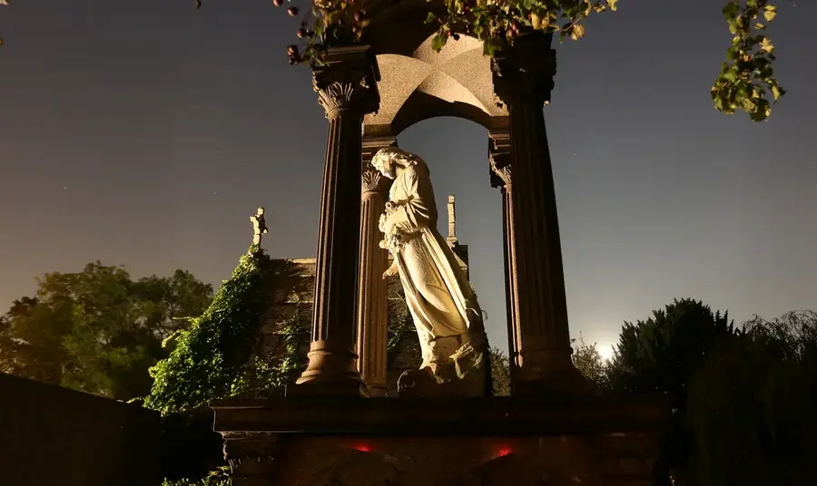 West Norwood Cemetery is one of London's Magnificent Seven Statue at West Norwood Cemetery lit up at night