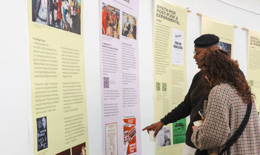 Two people looking at a display at the Sound Waves exhibition launch. 