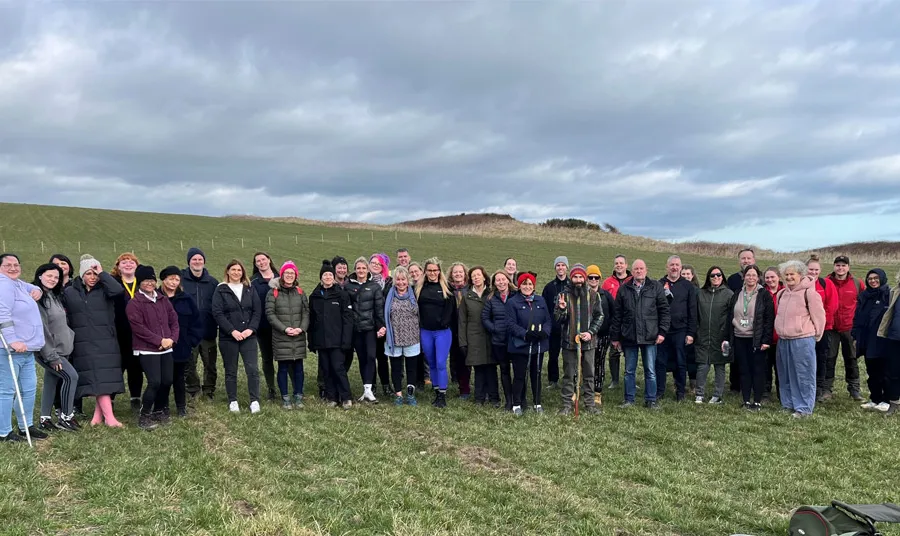 A large group of people stand together outdoors in the newly created nature reserve