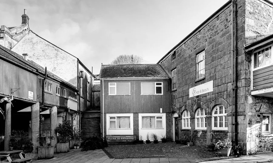 A black and white image of the buildings that make up the Buttermarket standing empty and in need or repair
