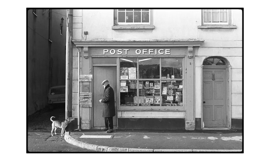 A man and his dog pictured outside a post office