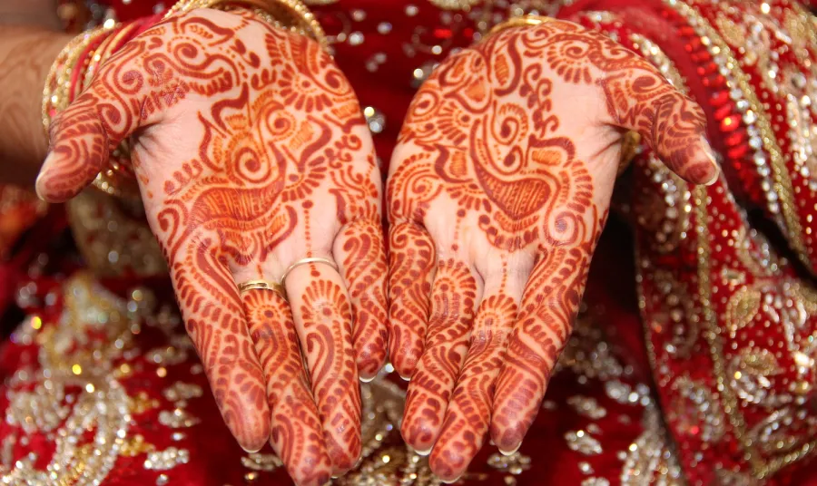 Picture of hands decorated in henna for a traditional South Asian wedding ceremony