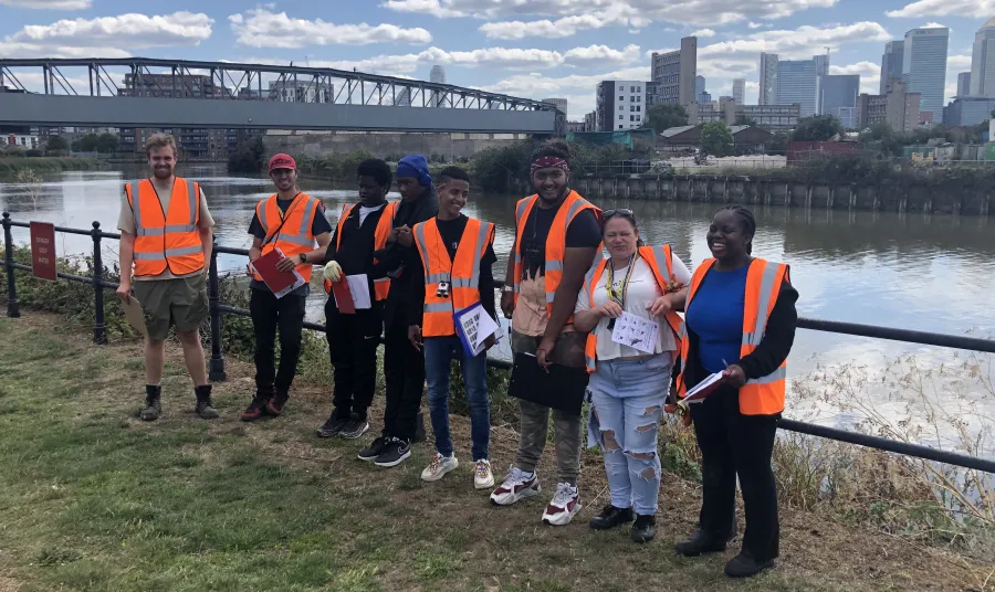 Group of young people standing in front of river