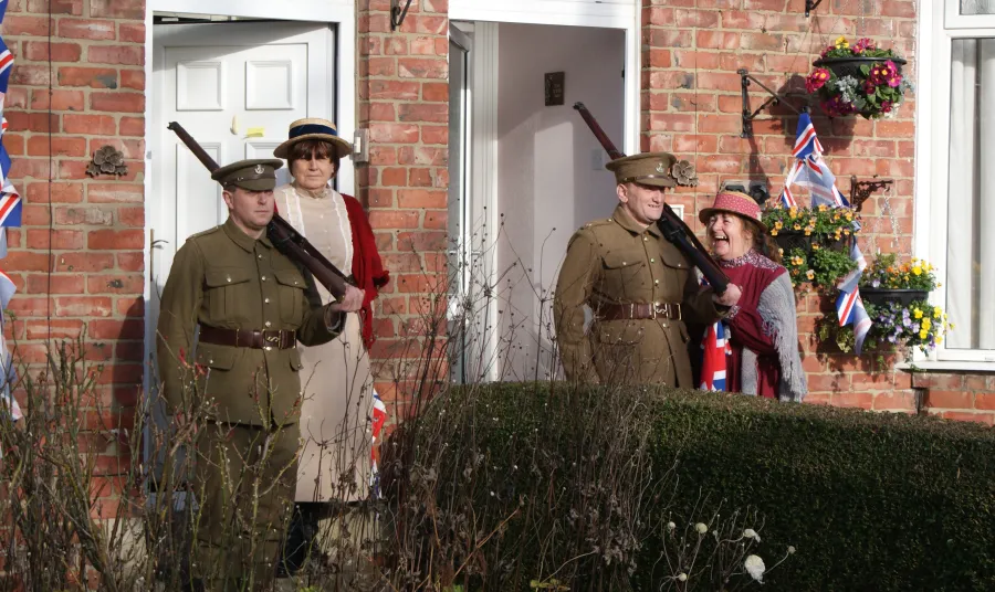 Two men dressed as soldiers standing at their front door