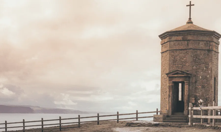 Octagonal brick structure with roof with a cross on the cliff tops above Bude in Cornwall.
