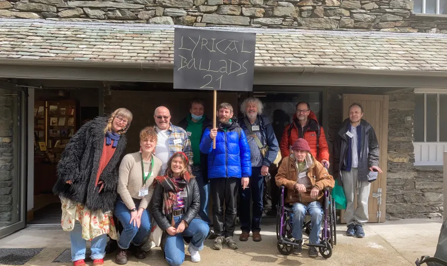 A group of people standing in front of Wordsworth Museum. One of them is holding a sign that reads 'Lyrical Ballads 21' 