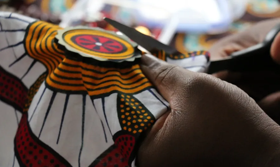 Close up photo of someone sewing at the Bam sistahood project