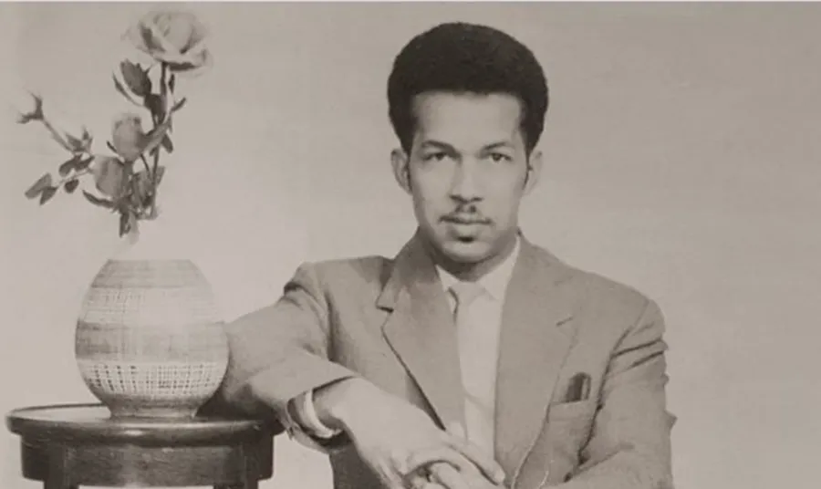Black and white photograph of man sitting down