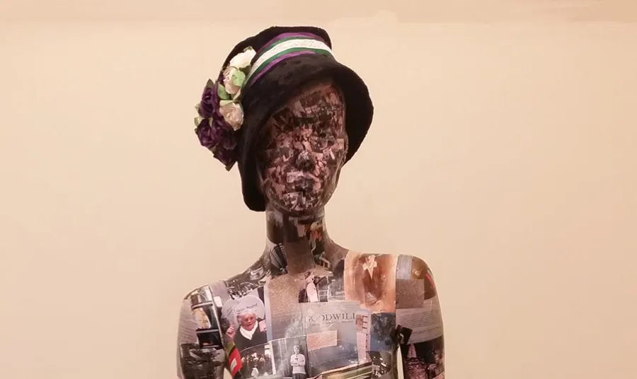 A mannequin covered in photos and documents. Volunteers created the 'Wo-Mannequin' from photos of the research, visits and materials they collected during the project