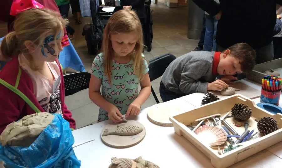 Children make clay fish