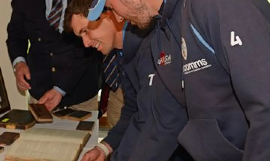 Players from Derbyshire County Cricket Club examine the exhibits