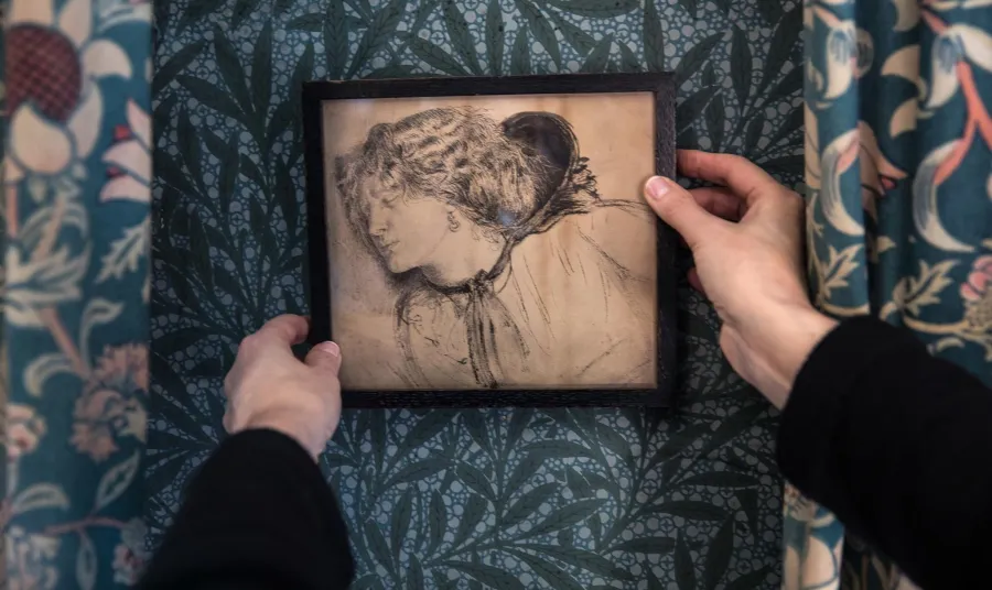 Two hands holding a drawing
