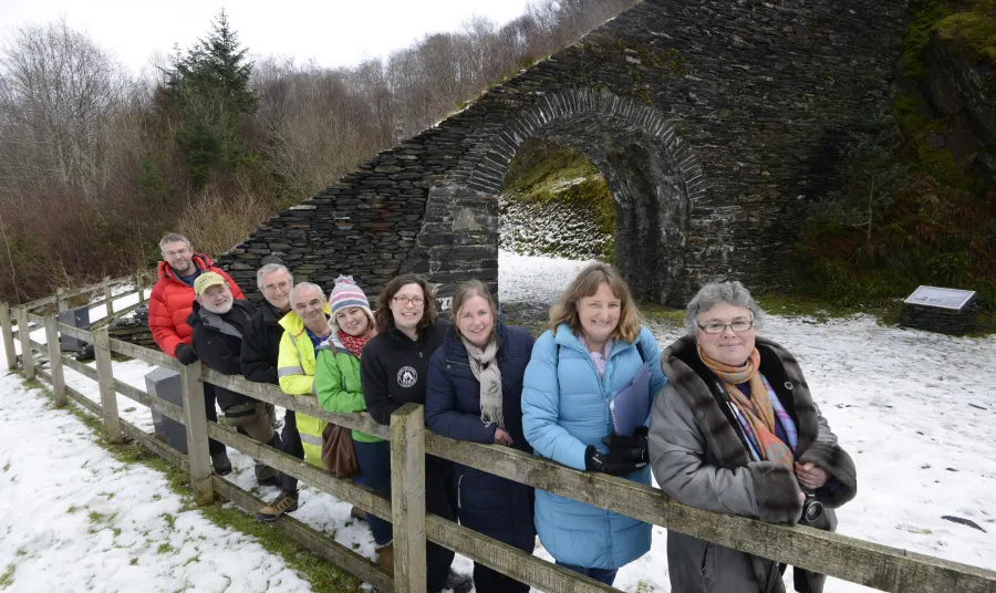 Ballachulish Community Committee members and Highland outside the Ballachulish arch