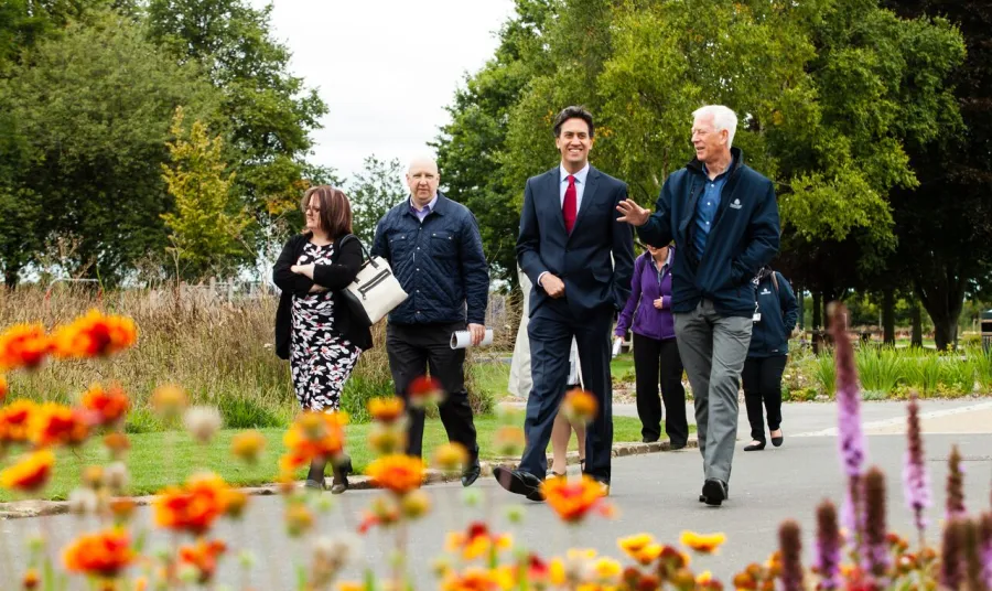 Ed Miliband walking through Bentley Park