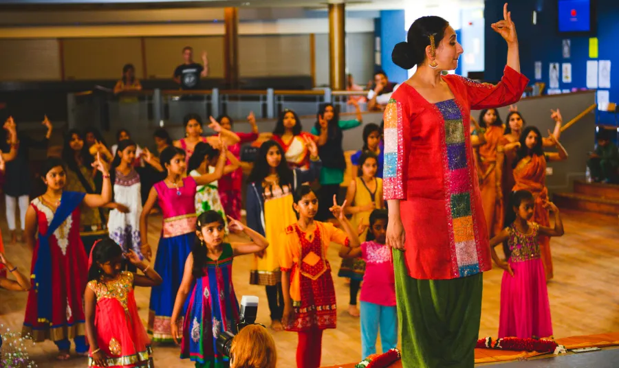 Children learn a South Asian dance 