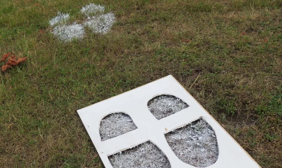 Stencil of footprints on grass