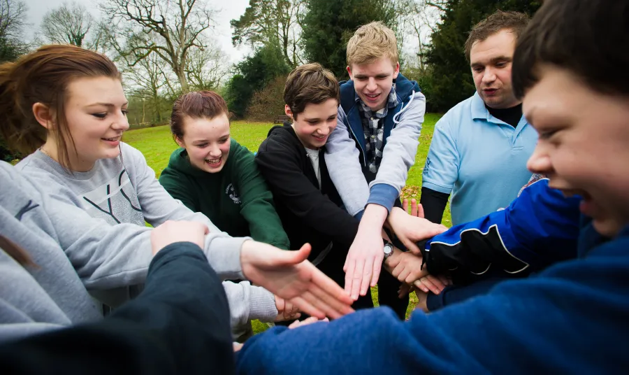 Young people teambuilding in a park