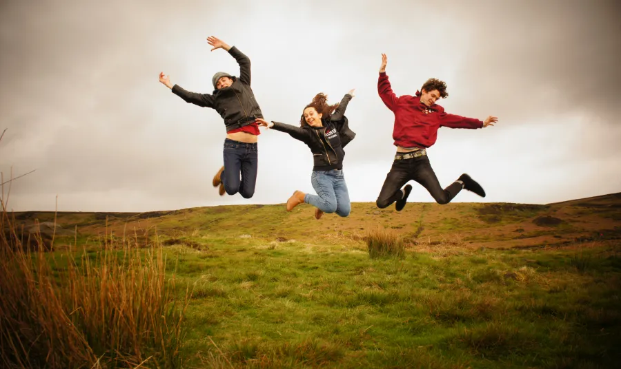 Young people jumping in a field