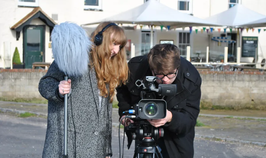 Students looking into a camera