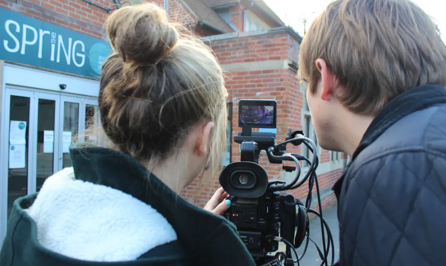 Students looking through a camera