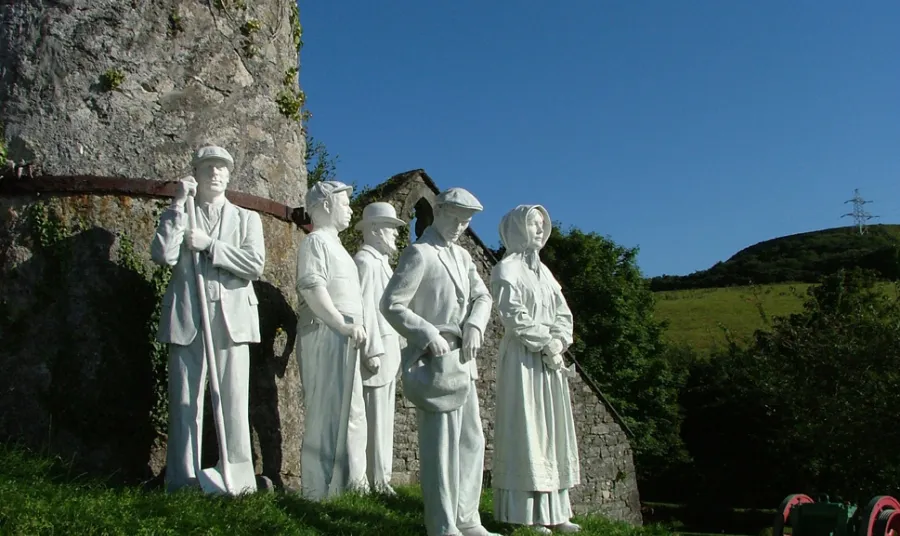 White statues of Victorian workers at the clay mine