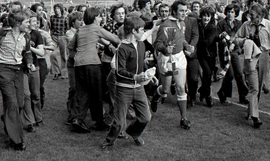 Scarlets captain Phil Bennett surrounded by fans after the club were crowned Welsh 'cup kings' in 1975
