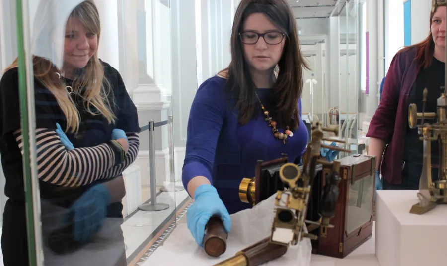 Young curator Bethany helping with an installation at the National Museums Scotland
