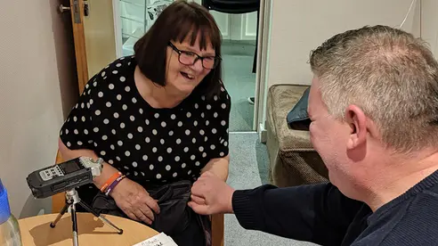 A volunteer conducts a face to face interview