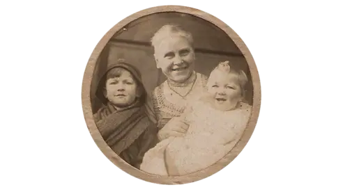 a historic photograph of Mary Blagg as an older woman with two children, believed to be Belgian refugees during the First World War