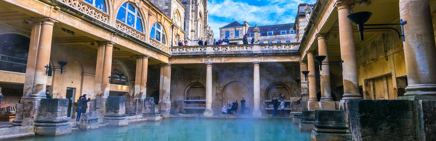 View of The Great Bath in Bath, Somerset, showing the water surrounded by Roman architecture. 