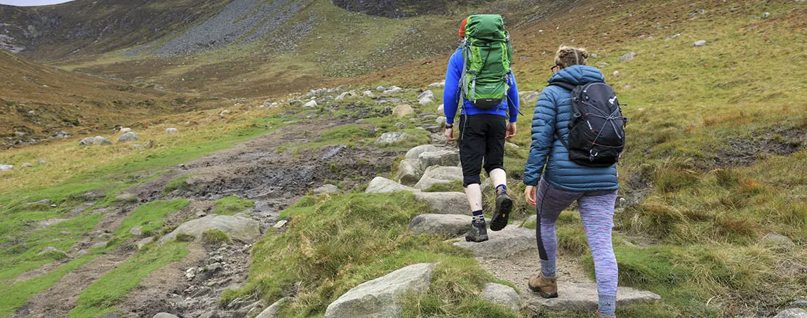 Two hikers walking in the hills