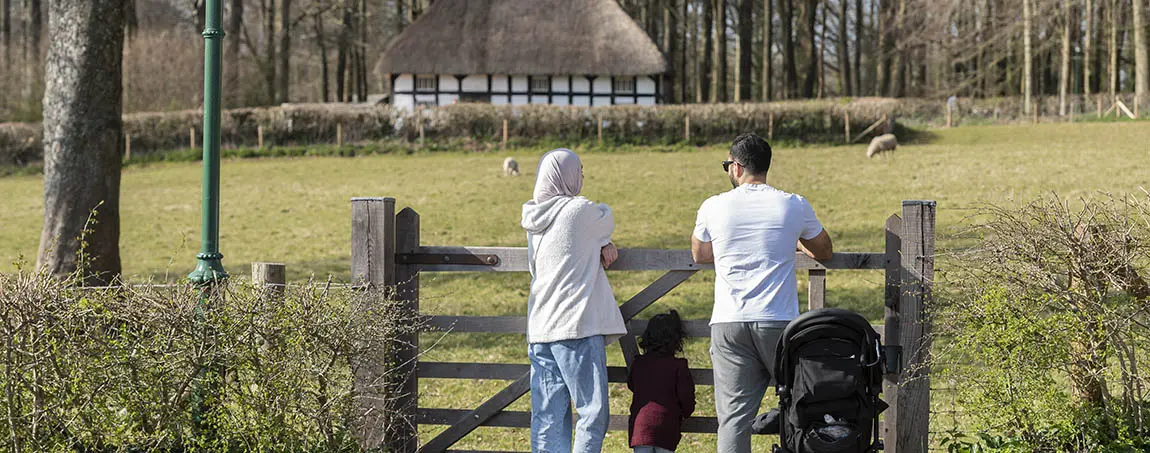 A family looking over a gate