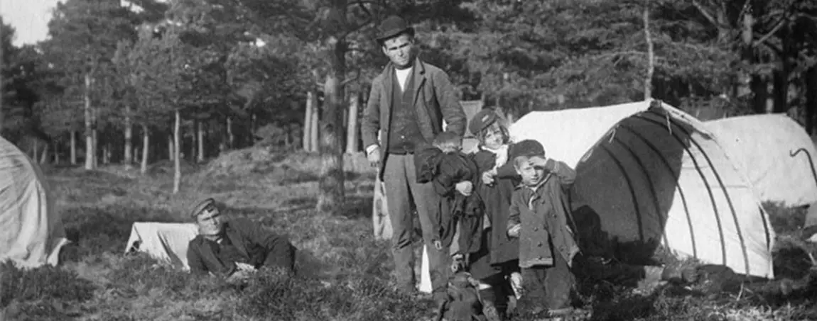 A black and white photo of a family camping in the late nineteenth century