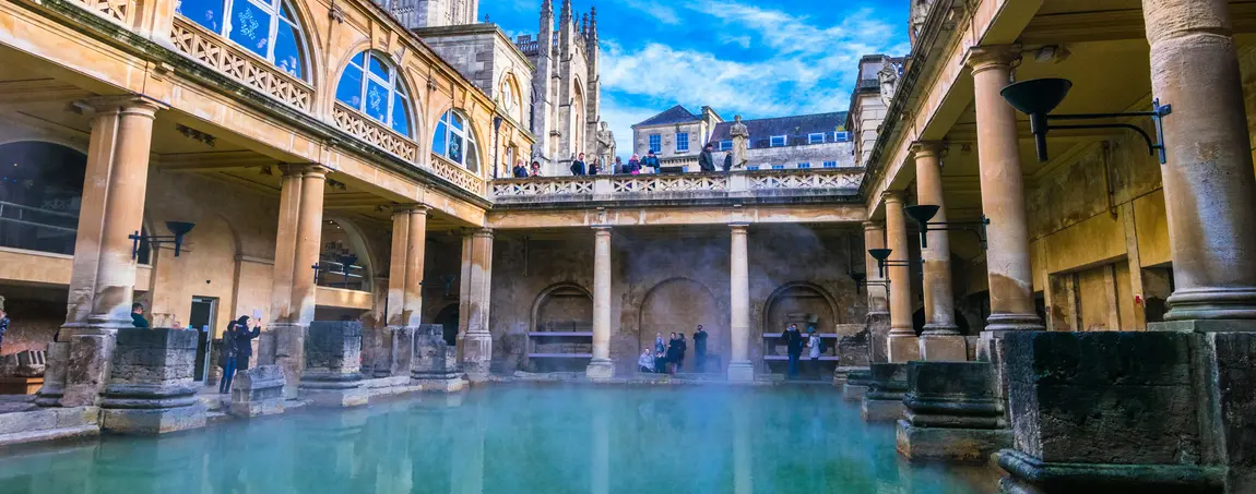 View of The Great Bath in Bath, Somerset, showing the water surrounded by Roman architecture. 