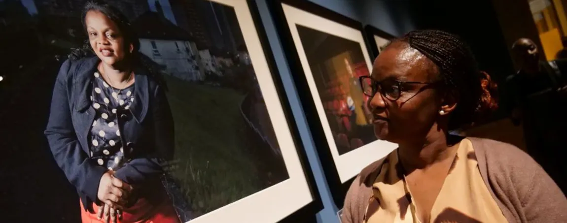 A person looks at a portrait in a gallery