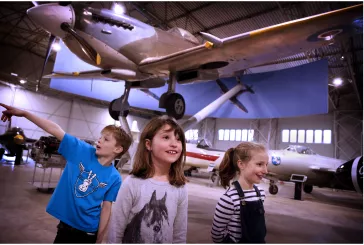 Children looking and pointing at aeroplanes